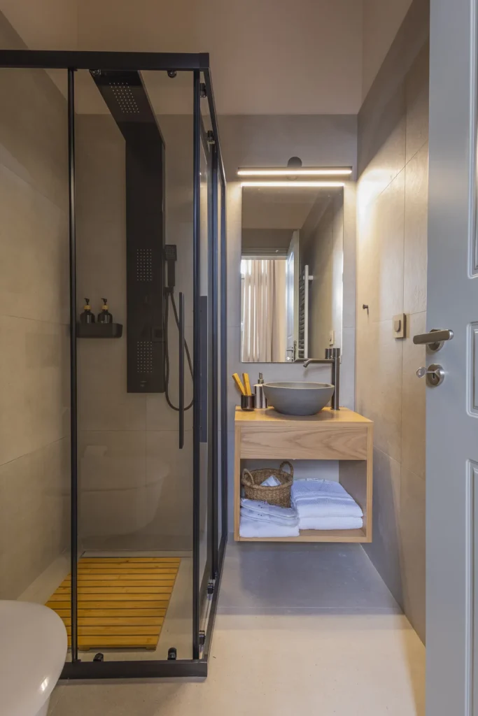 Bathroom of the Classic Studio with a hydromassage shower and timber vanity