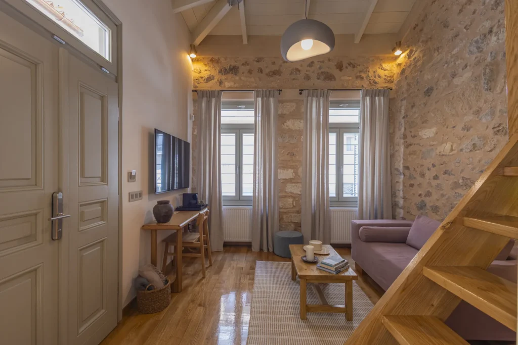 Deluxe Studio living room with tall street-facing windows and a panelled door