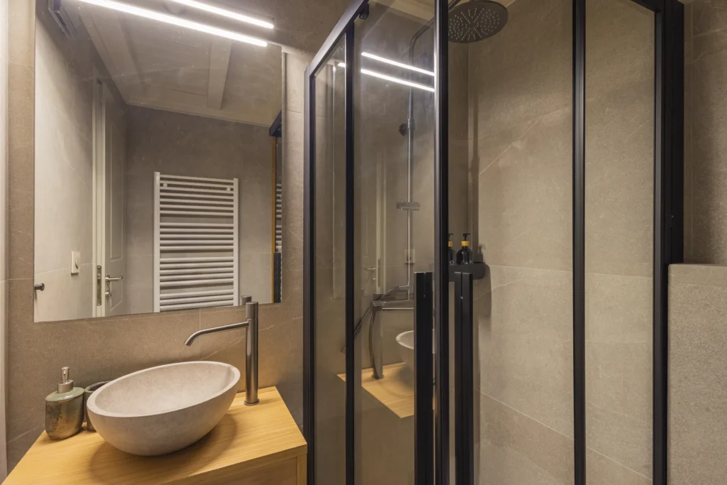 Junior Suite bathroom with a stone vessel sink and glass shower