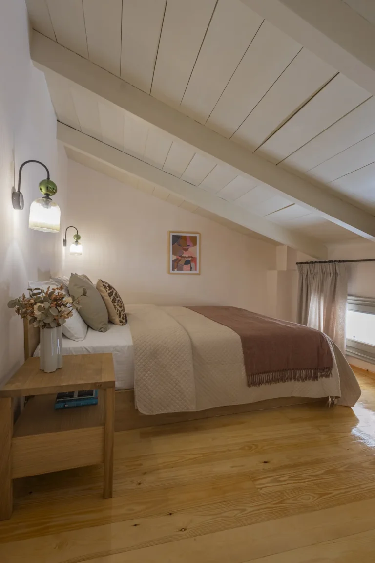Loft bedroom of the Superior Studio with a sloped timber ceiling